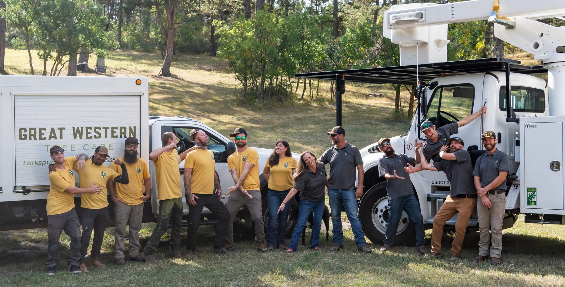 The Great Western Tree Care crew in company shirts lined up in front of their equipment truck