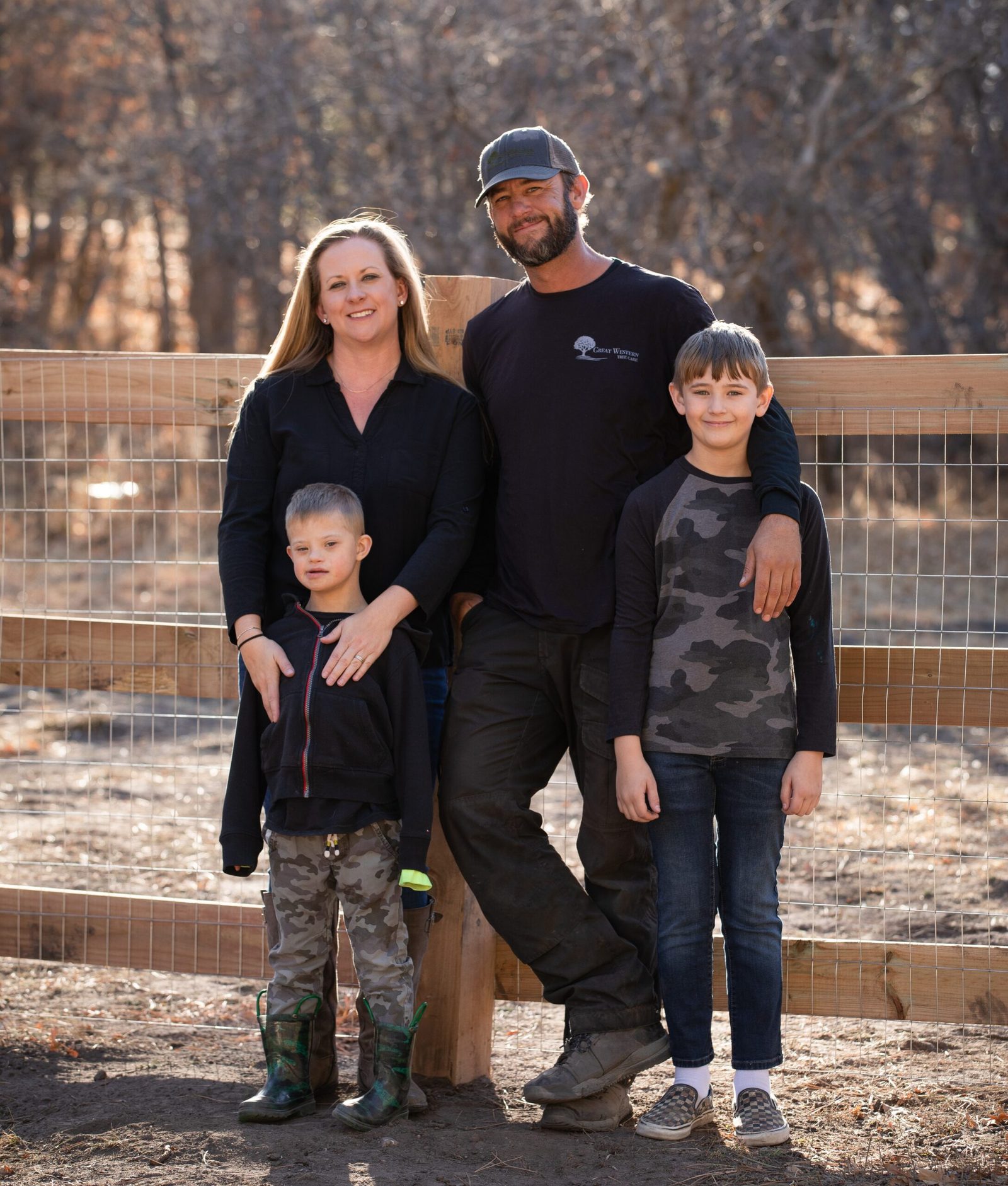 The Great Western Tree Care founding family standing together outdoors with their children
